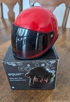 Clock atop box showing helmet shape and visor