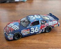 Left-front side view showing #36, M&M's graphics, tire detail