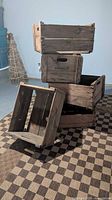 Stack of five rustic wooden fruit crates showing overall condition and size