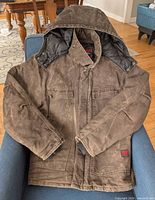 Full view of brown Tough Duck hooded coat laid flat on chair
