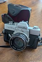 Front view of Minolta SR-T 101 camera with 50 mm lens and attached half-case