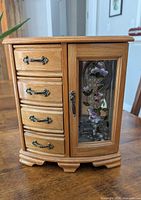 Front view of wooden jewelry box closed