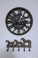 clock and hook rack mounted on wall