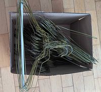 Box filled with stacked metal wire hangers
