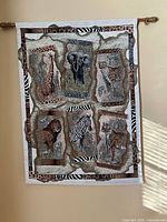 Front view of entire African animal tapestry on wall