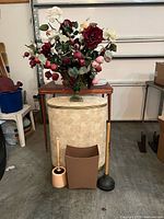Full lot view showing hamper, floral arrangement, wastebasket, toilet brush, plunger