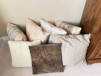 Group of seven pillows showing variety of patterns and colors