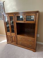 Front view of full oak hutch showing glass doors, drawers and overall design