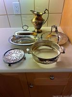 Group shot of all six silver-plated serveware items on countertop