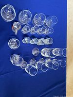overhead view of all 23 glass pieces on blue cloth