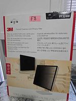 Front of box showing 3M branding, product images, privacy filter graphic