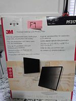 Front of 3M PF317 privacy filter box showing product images and multilingual text