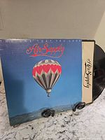 Front cover with hot-air balloon artwork and partial vinyl visible