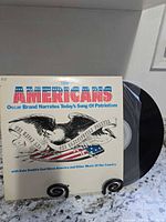 Front cover and vinyl record of "The Americans" LP