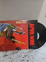 Front jacket and partially pulled black vinyl record