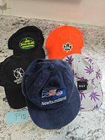 Group of five hats displayed