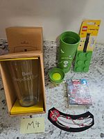 All items overview: tumbler in box, Starbucks bottle, LEGO tag, sealed minifigure, patch