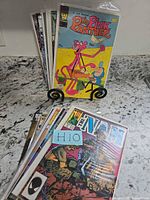 Front view of assorted comic stack; The Pink Panther cover visible at front, others behind