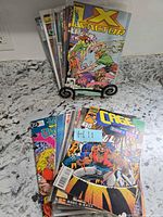 All 20 comics, two stacks on countertop, X-Factor visible front