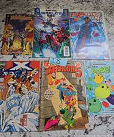 All six comic books laid out front covers visible