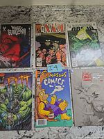 All six comics laid out fronts visible