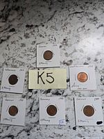 Six 2 Pfennig coins in flips around label K5