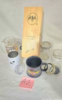 Overview of all items: Bacardi wooden box, beer mug, travel tumbler with lid, ceramic mug, two Mason jars with lids