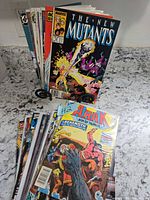 Stack of 20 bagged comic books on counter; front shows The New Mutants cover