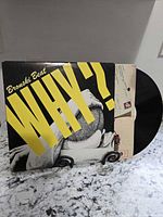 Front cover of Bronski Beat Why? sleeve with vinyl partly visible