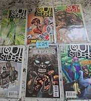 All six bagged Outsiders comics laid out