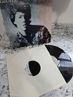 Front of album jacket with record partially visible