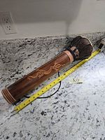 Full view showing entire drum with measuring tape for scale