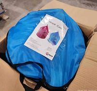 Folded blue carry case with product sheet inside box