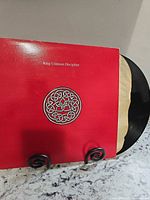 Front of King Crimson Discipline sleeve and partially visible vinyl