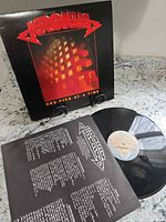 Album jacket, vinyl record, lyric sleeve visible