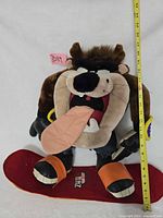 Front view showing full plush, measuring tape shows height