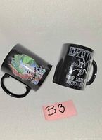 Two black ceramic mugs angled to show Hendrix and Led Zeppelin graphics