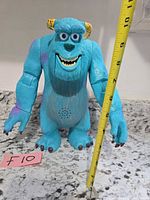 Front view showing figure height with tape measure ~12 in