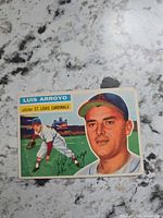 Front of 1955 Topps Luis Arroyo #64 card showing portrait, action image, name and team