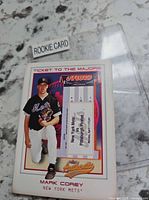 Front of Mark Corey Authentix card in sleeve showing ticket fragment and serial area