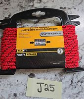 Front view of packaged red braided polyester rope on plastic spool with label showing specifications