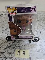 Front view of sealed Funko Pop Icons Whitney Houston figure box showing figure and box art