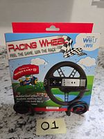 Front of retail box showing black racing wheel accessory compatible with Wii U & Wii