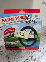 Front view of boxed Racing Wheel accessory showing compatibility details and Mario Kart 8 reference
