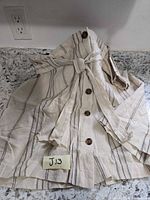 Full skirt front view showing buttons, belt, stripes