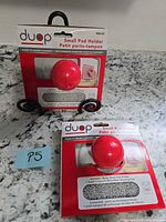 Front view of two boxed Duop small pad holders