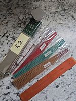 Complete kit with tin, labeled stick bundles and wooden holder