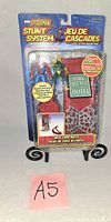 Front of sealed Spider-Man Stunt System Web Trap Hotel playset packaging
