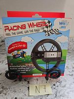 Front of retail box showing dreamGEAR Racing Wheel accessory compatible with Wii and Wii U