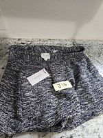 Full view of marled knit shorts with tag attached
